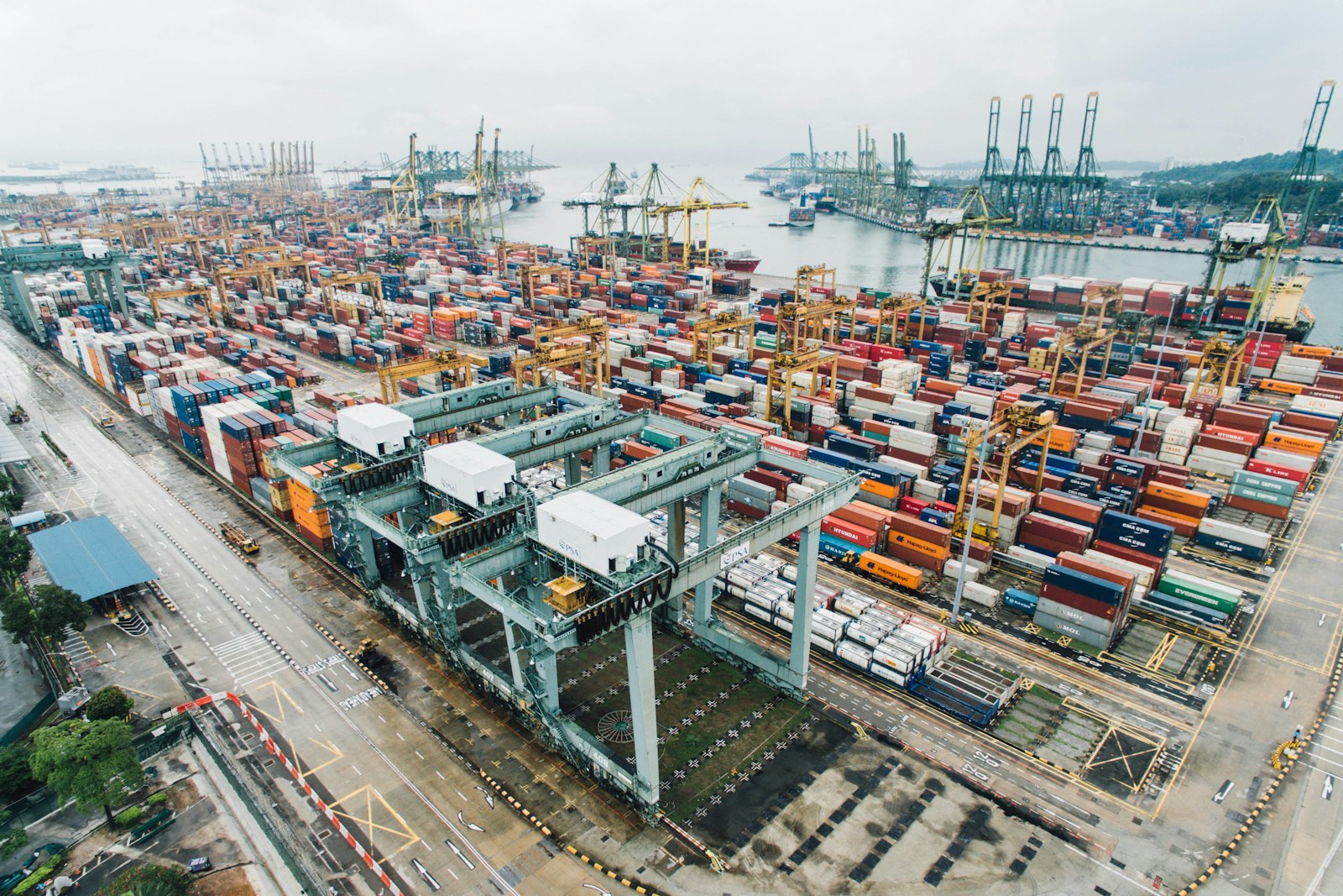 Cargo ship being loaded with shipping containers at a commercial port