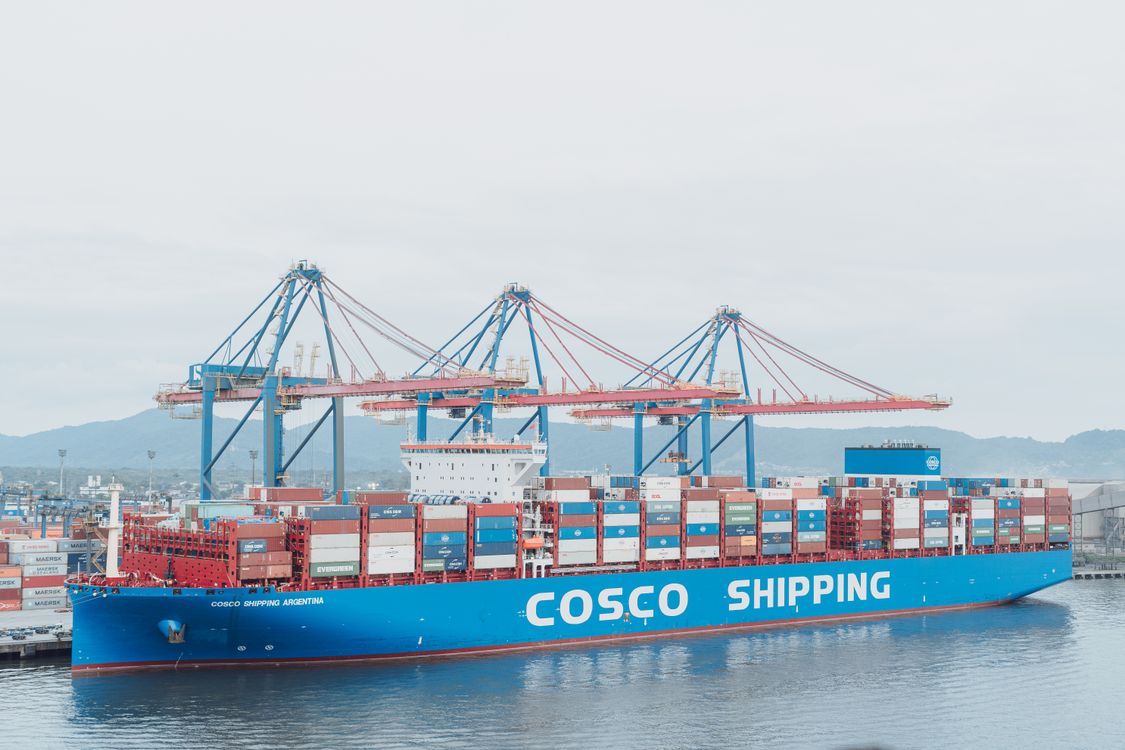 Container ship berthed alongside port cranes