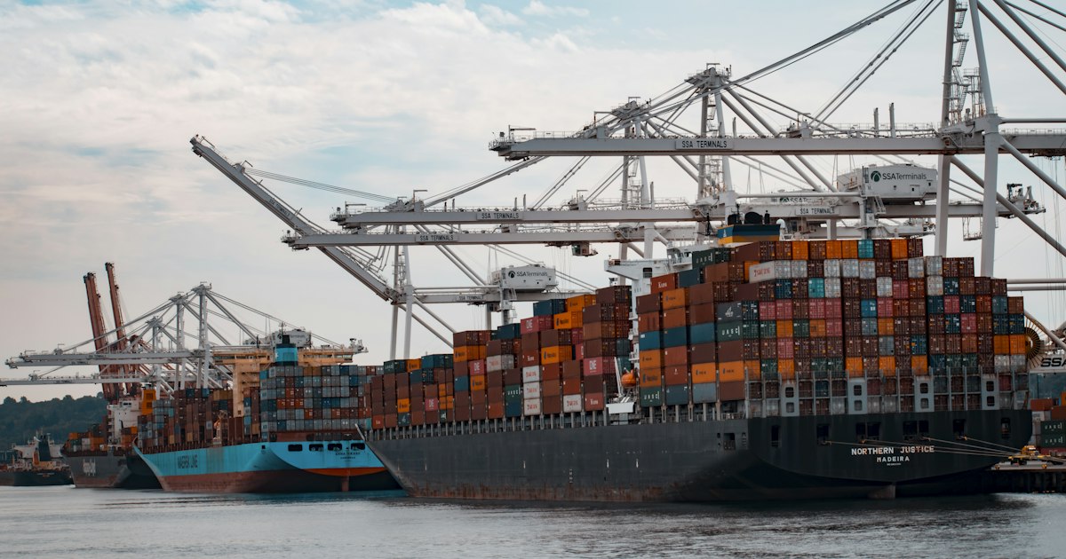A large cargo ship loaded with stacked shipping containers at sea