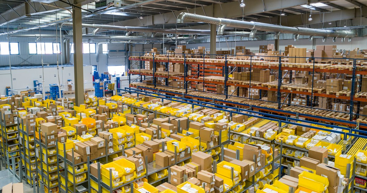 Aerial view of a warehouse facility with loading docks and delivery trucks