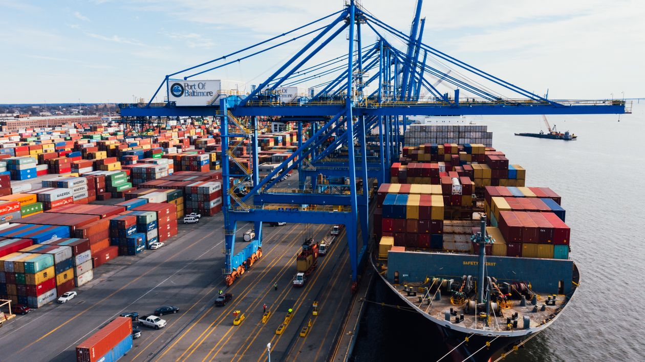 Cargo ship unloading containers at a busy port