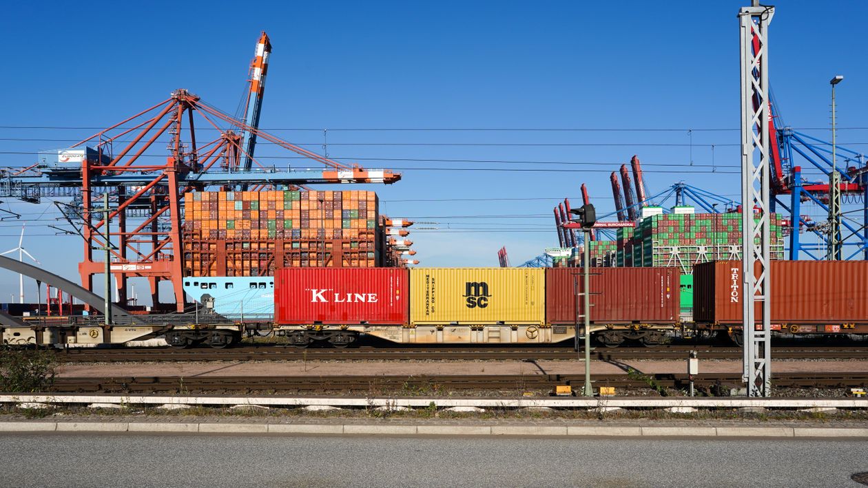 Shipping containers and industrial cranes at a busy port, illustrating freight and logistics infrastructure