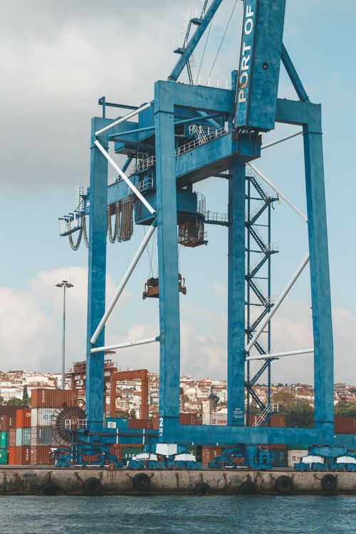 Shipping containers and gantry cranes at a busy container port