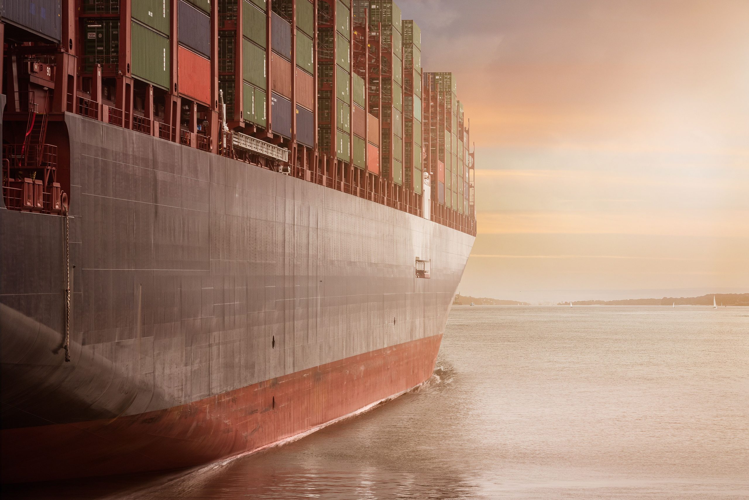 Container ship berthed at a port terminal with stacked containers