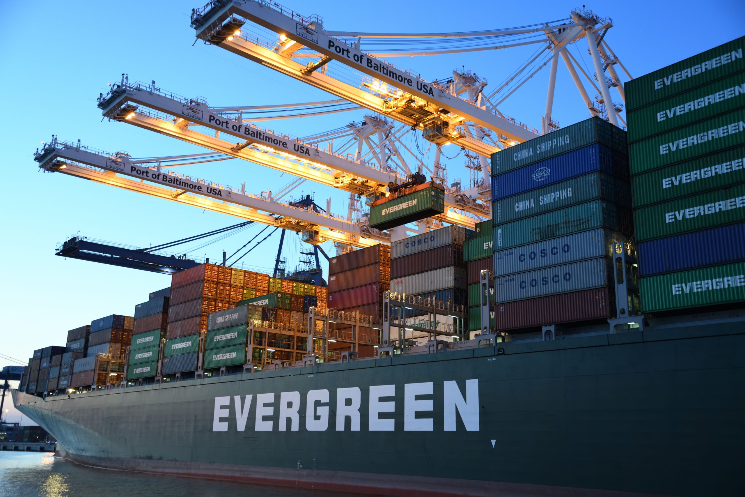 Aerial view of a container port with gantry cranes loading cargo ships